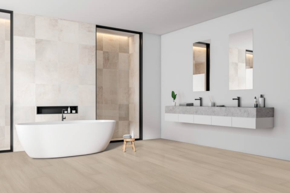 wood look flooring in bathroom with white tile walls.